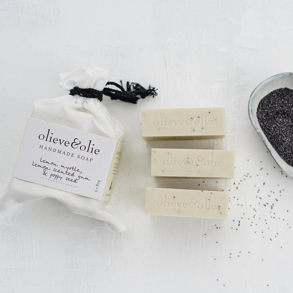 Olieve & Olie Lemon Myrtle & Poppy Seed Handmade Bar Soap 3 Pack presented in a white calico bag on a white background. Three handcrafted olive oil soaps made using the traditional cold process method, gently cleansing and lightly exfoliating while helping maintain the skin's natural moisture balance